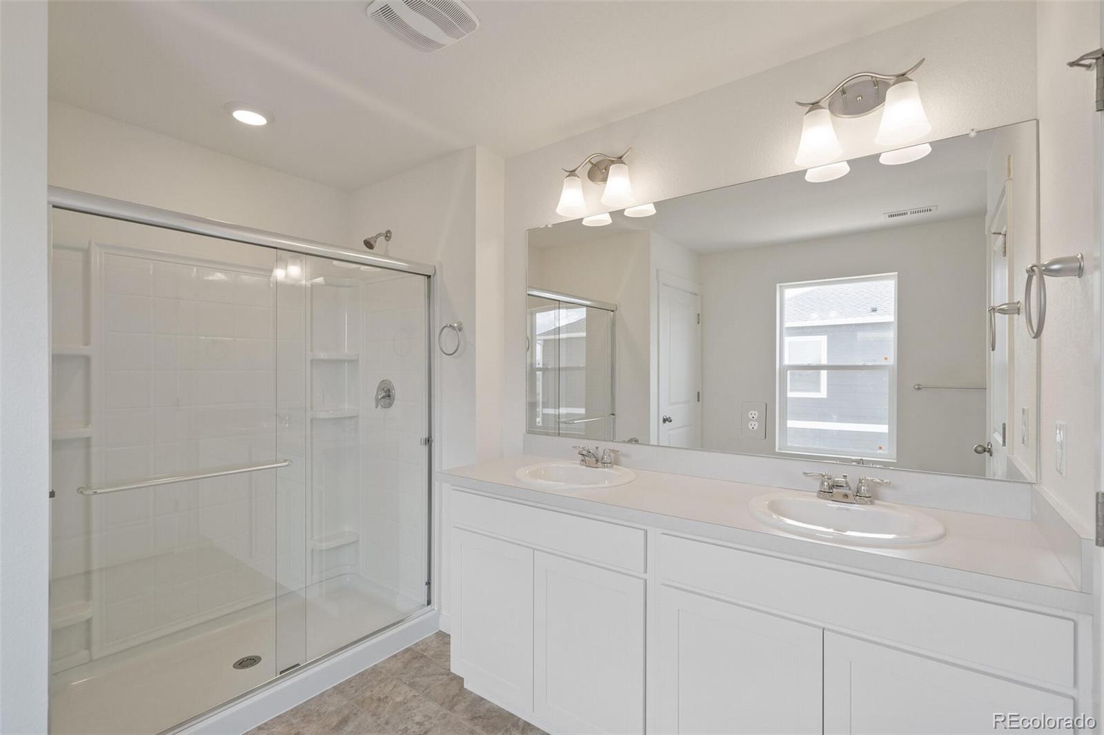219 Haymaker Lane Severance, CO 80550 - Photo 22 of 44 a bathroom with sink shower and mirror