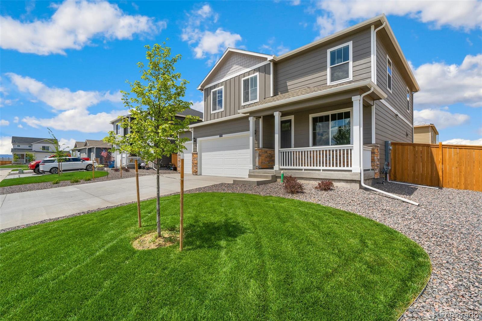 219 Haymaker Lane Severance, CO 80550 - Photo 3 of 44 a front view of a house with a yard and car parked