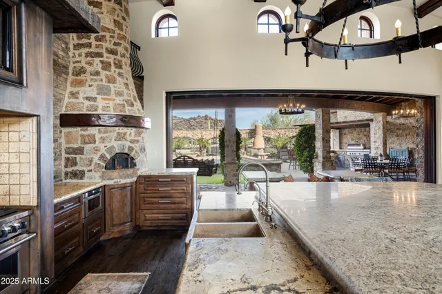 a kitchen with a stove kitchen island and living room