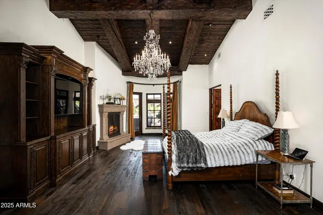 a bedroom with a bed and a chandelier