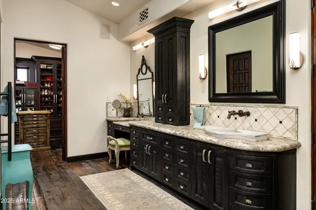 a spacious bathroom with a tub sink and mirror