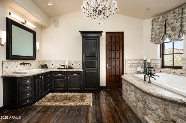 a bathroom with a bathtub a sink and a window