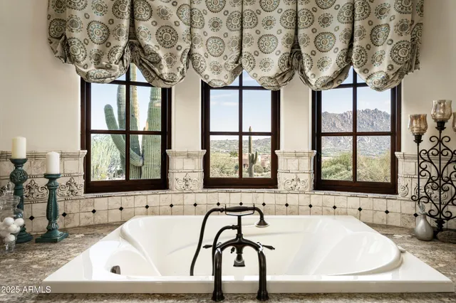 a kitchen with stainless steel appliances granite countertop table chairs and a refrigerator