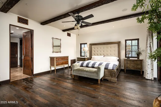 a bedroom with a large bed and a large window