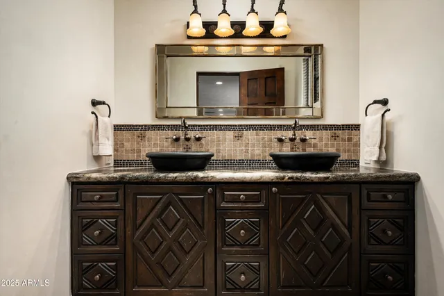 a dining room with furniture a chandelier and wooden floor