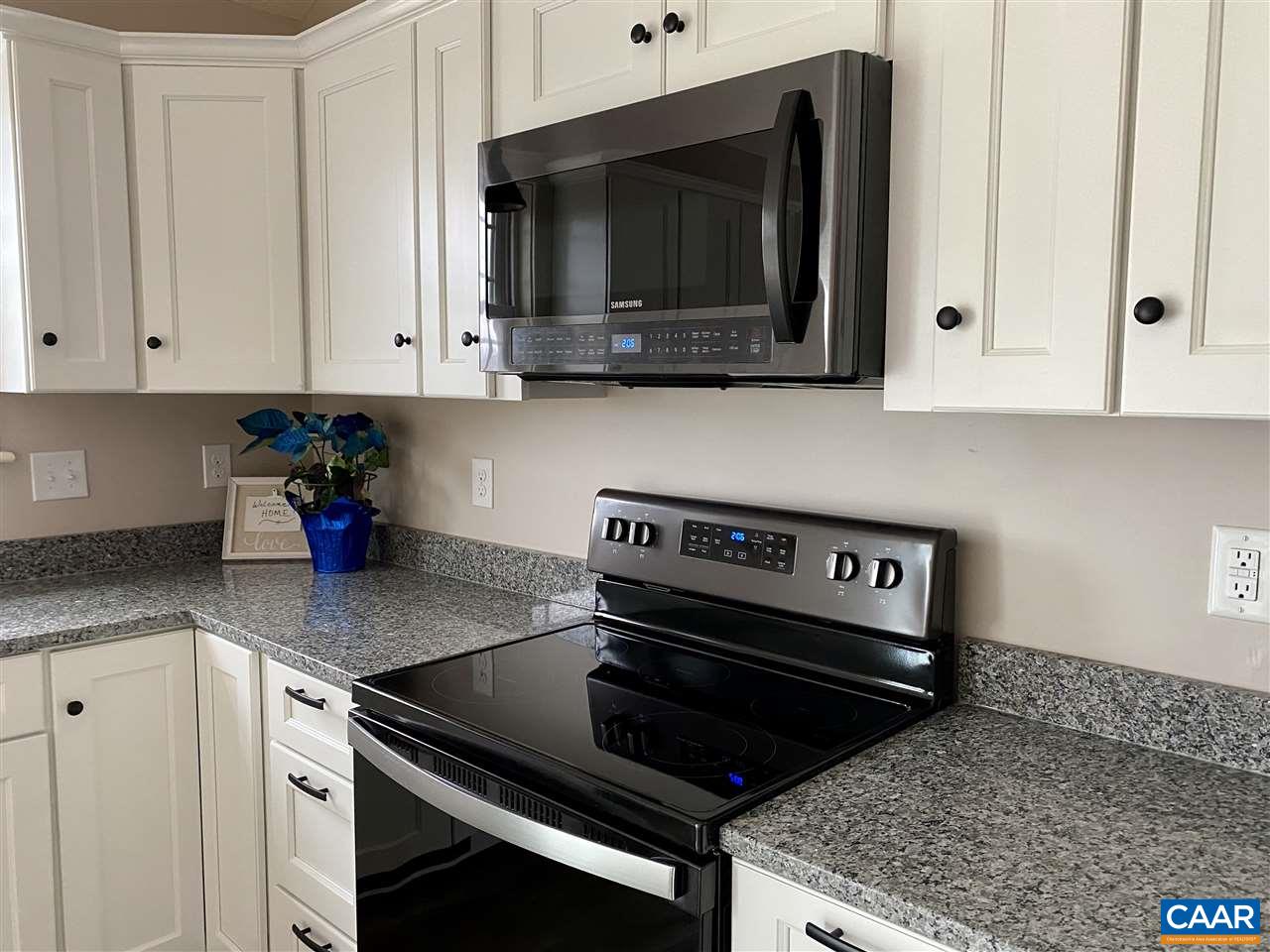 907 New Hope Road Staunton, VA 24401 - Photo 19 of 50 a kitchen with microwave cabinets and stove top oven