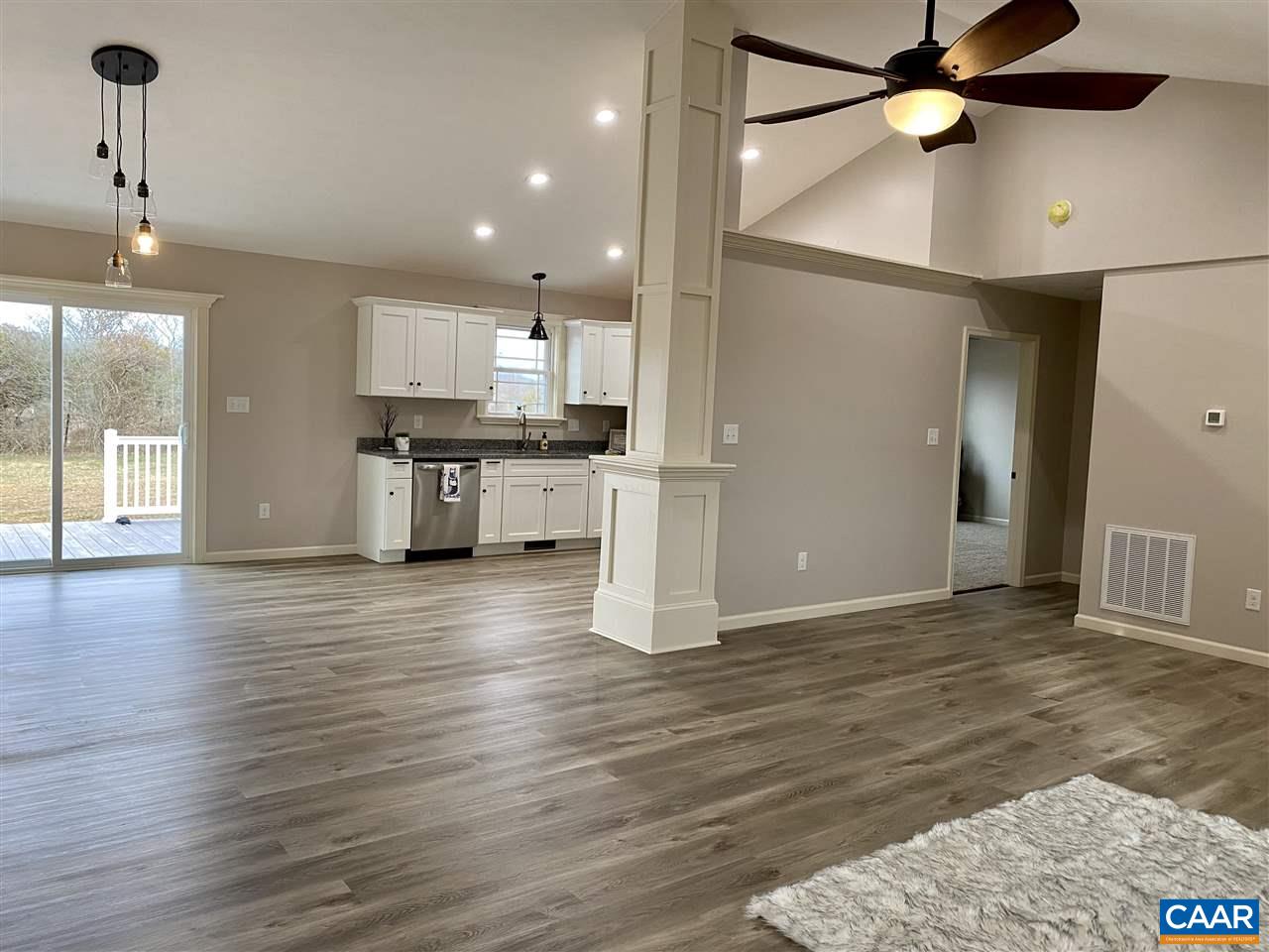 907 New Hope Road Staunton, VA 24401 - Photo 49 of 50 an empty room with wooden floor a ceiling fan and kitchen view