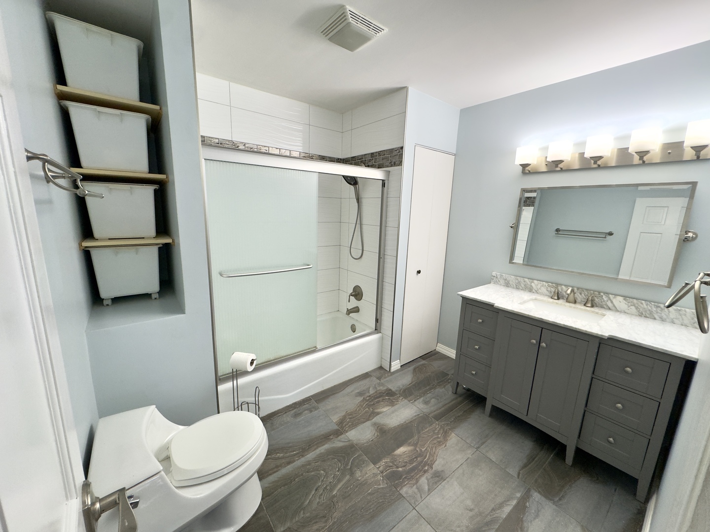 7210 Adams Street, Unit D Willowbrook, IL 60527 - Photo 11 of 19 a bathroom with a double vanity sink toilet mirror and shower