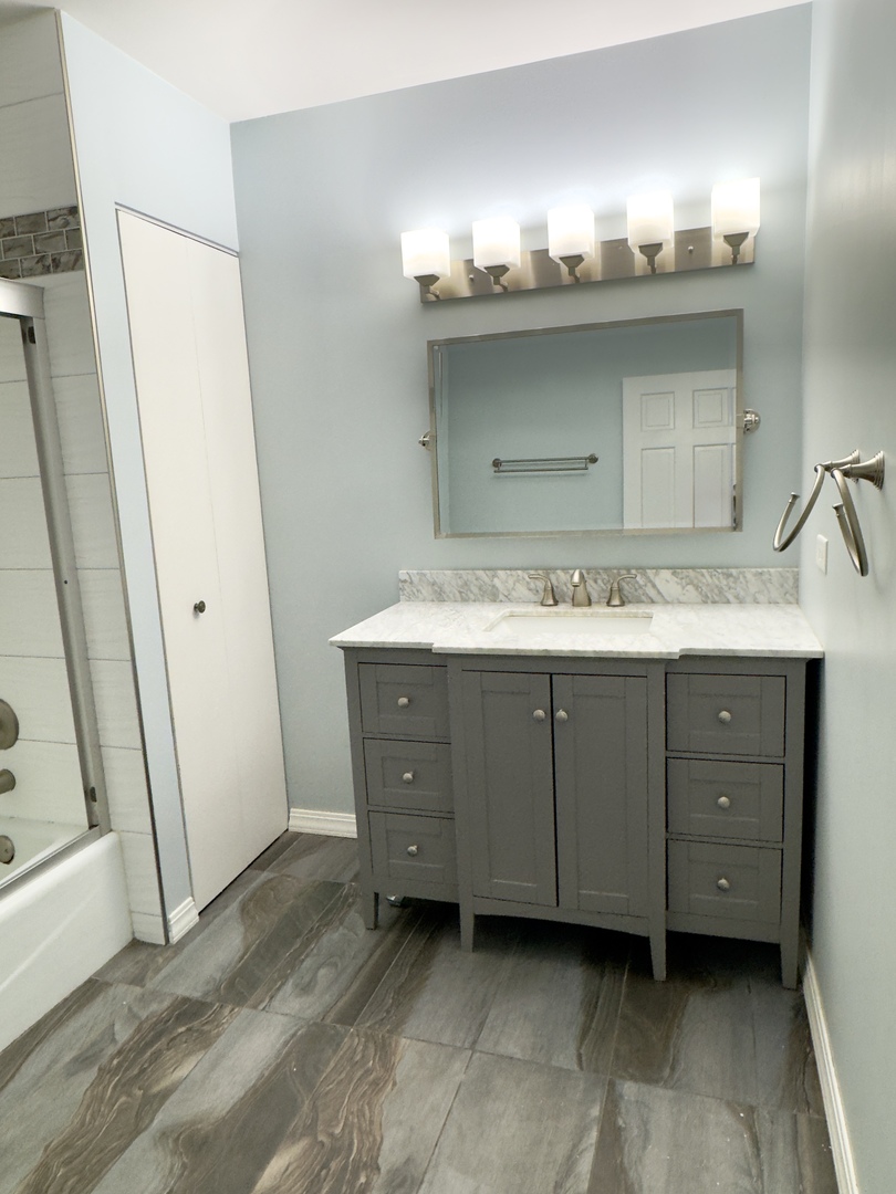 7210 Adams Street, Unit D Willowbrook, IL 60527 - Photo 12 of 19 a bathroom with a sink and mirror