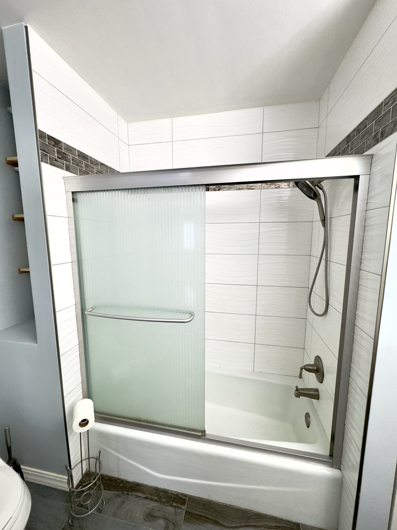 7210 Adams Street, Unit D Willowbrook, IL 60527 - Photo 13 of 19 a bathroom with a shower and a toilet