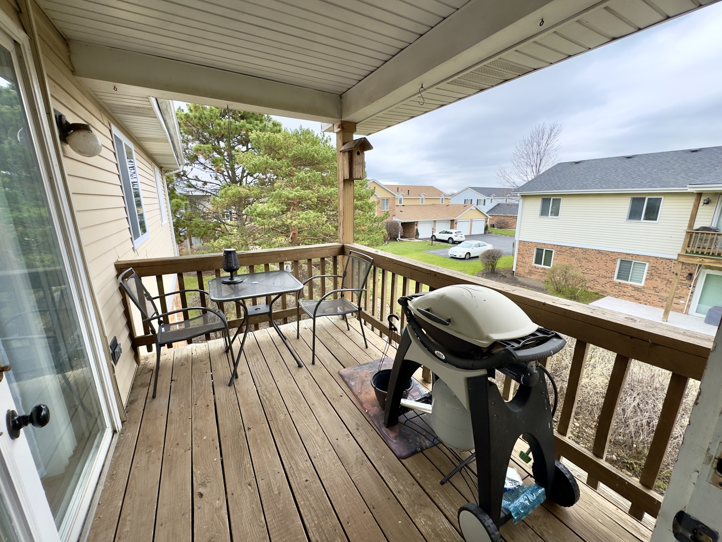 7210 Adams Street, Unit D Willowbrook, IL 60527 - Photo 18 of 19 a balcony with wooden floor table and chairs