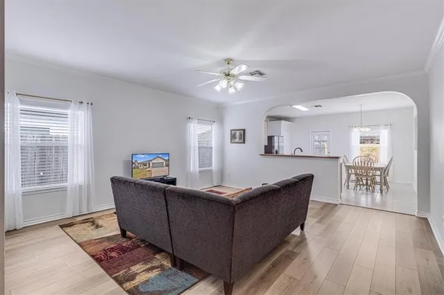 a living room with furniture and wooden floor
