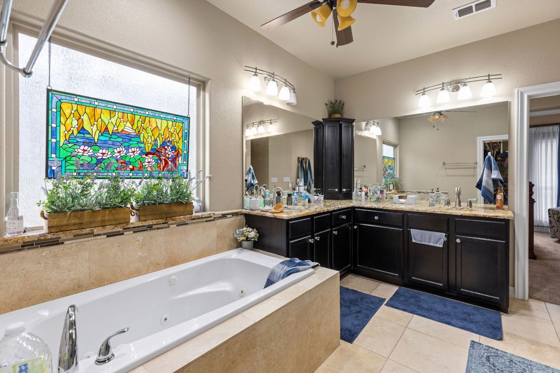 1291 Mossy Hollow Road Spring Branch, TX 78070 - Photo 11 of 23 a large bathroom with a large tub and sink