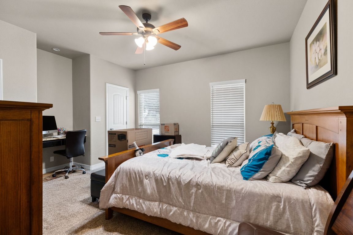 1291 Mossy Hollow Road Spring Branch, TX 78070 - Photo 12 of 23 a bedroom with a bed and a chandelier