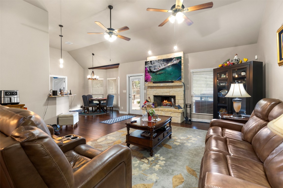 1291 Mossy Hollow Road Spring Branch, TX 78070 - Photo 5 of 23 a living room with furniture fireplace and a chandelier