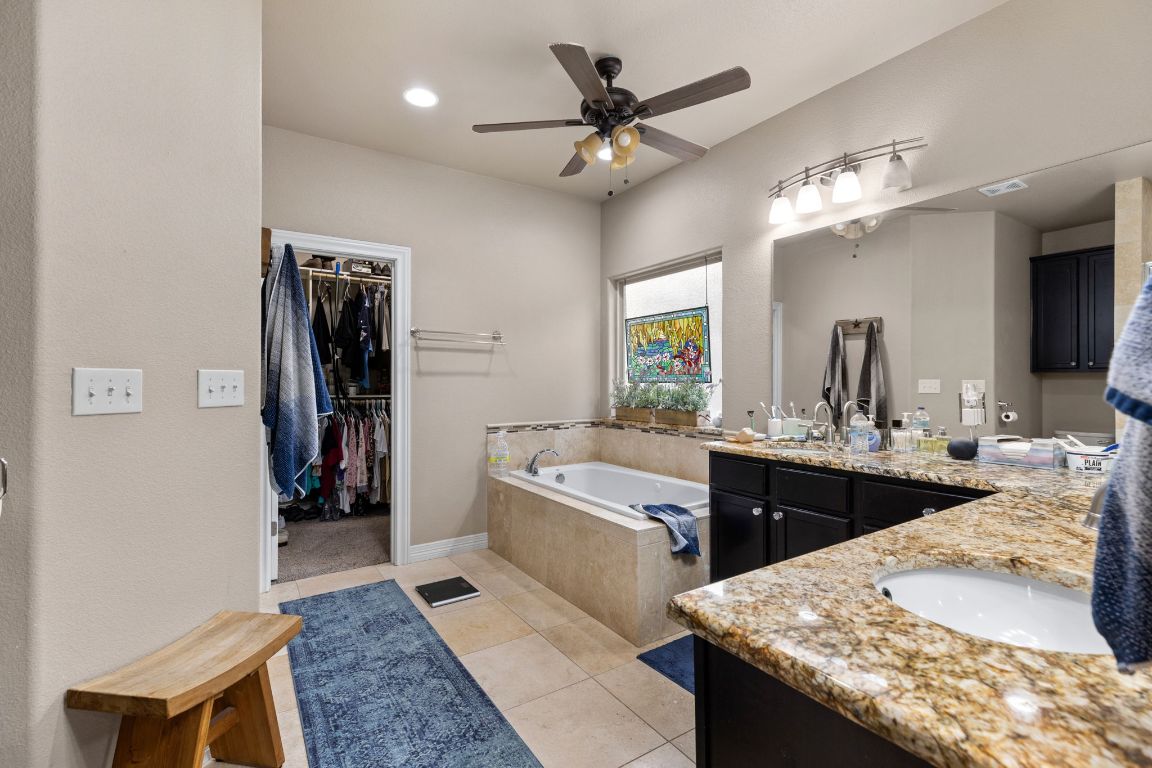 1291 Mossy Hollow Road Spring Branch, TX 78070 - Photo 10 of 23 a large bathroom with a granite countertop sink a toilet a mirror and shower