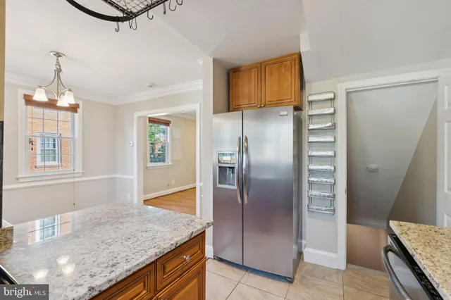 a kitchen with stainless steel appliances granite countertop a refrigerator a stove and a sink with granite countertops