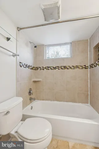 a bathroom with a toilet bathtub and shower