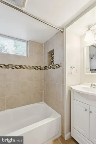 a bathroom with a shower a mirror and a sink