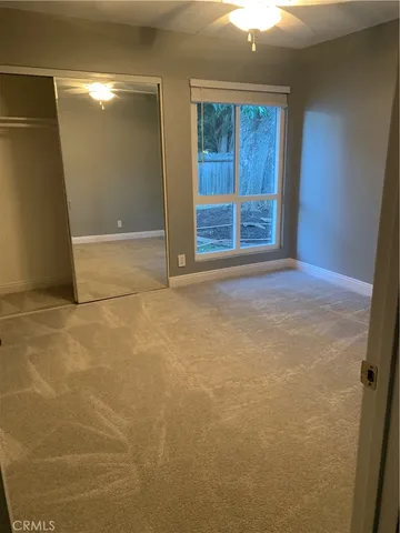a bathroom with a granite countertop toilet and a sink