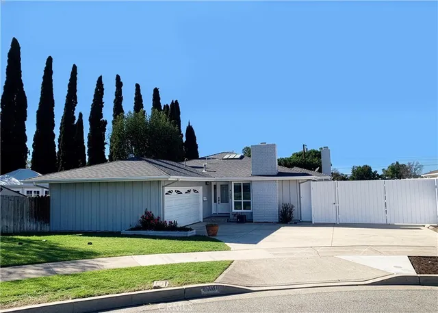 an empty room with wooden floor and a fireplace