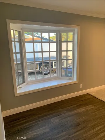 a view of a patio with a table chairs and a grill