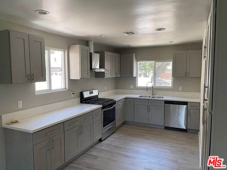 a kitchen with a sink stove and cabinets
