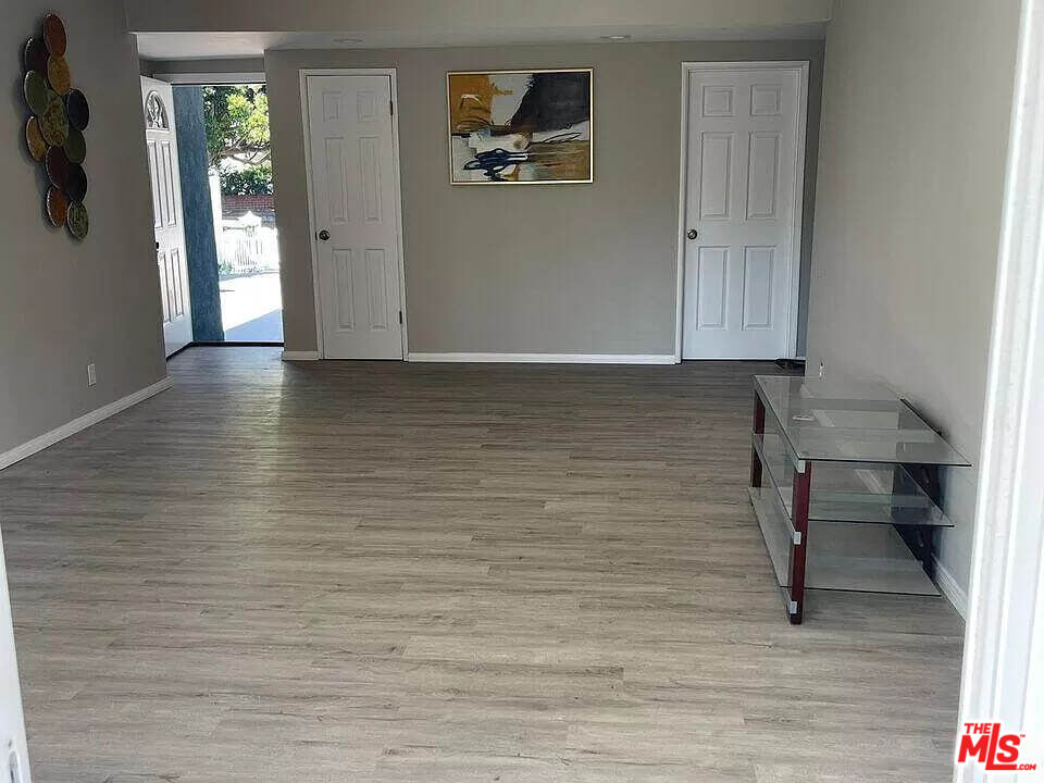 7669 Willis Avenue Van Nuys, CA 91405 - Photo 3 of 10 a view of room with window and wooden floor