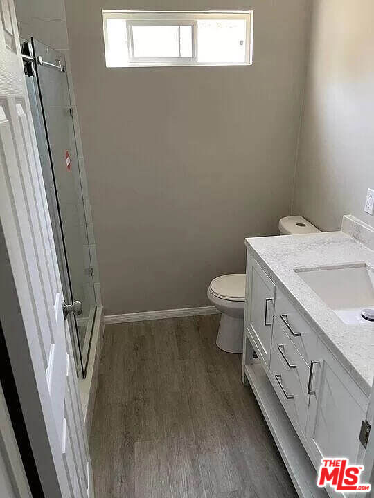 7669 Willis Avenue Van Nuys, CA 91405 - Photo 4 of 10 a bathroom with a granite countertop toilet and a sink