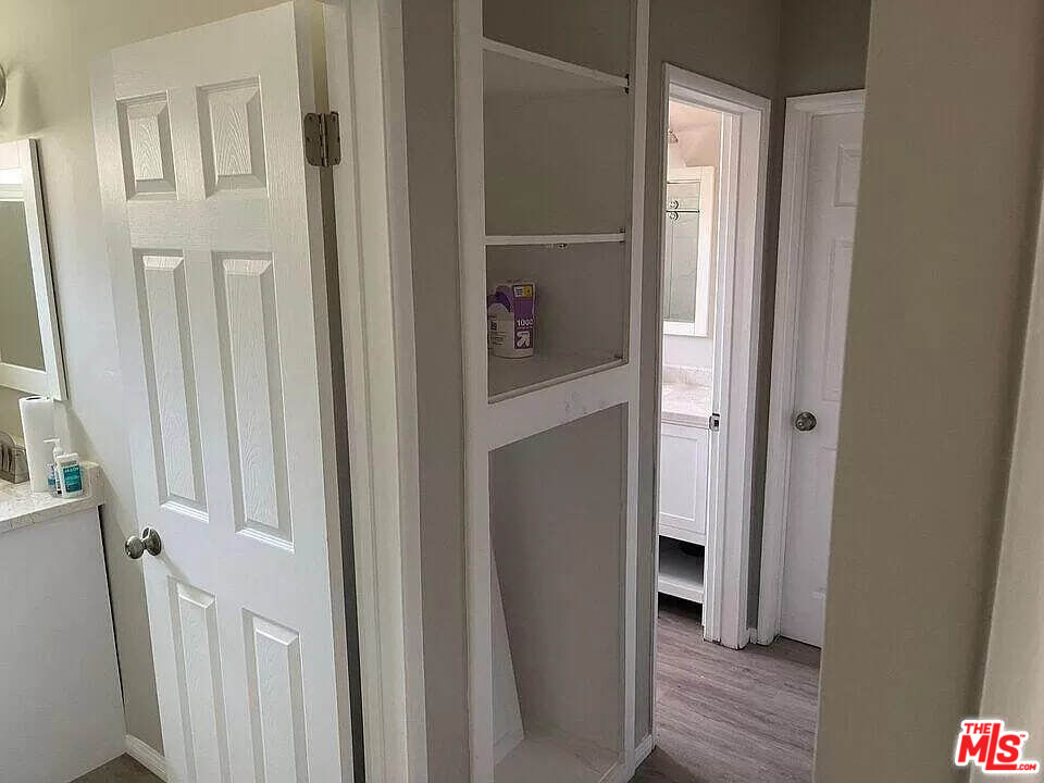7669 Willis Avenue Van Nuys, CA 91405 - Photo 5 of 10 a view of a hallway with wooden floor and closet