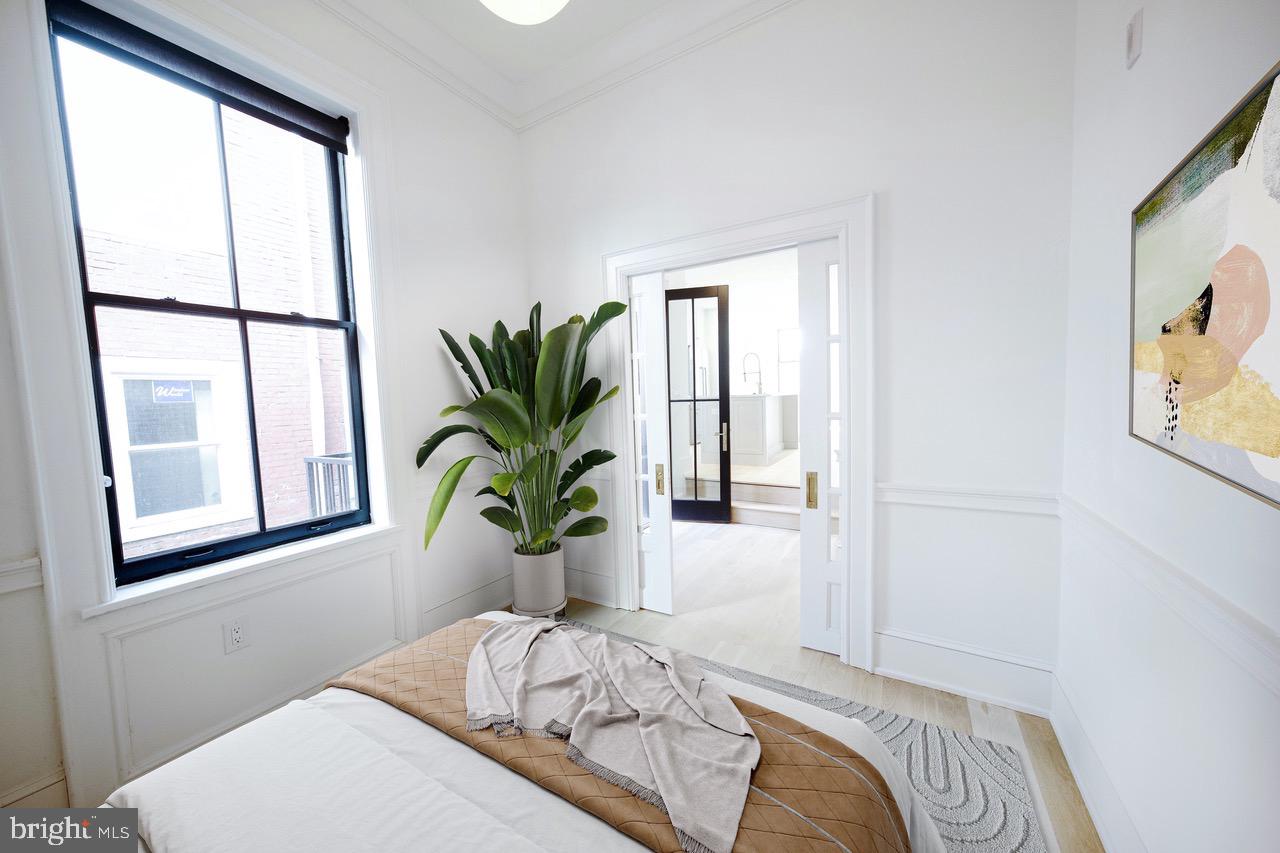 1227 North 6th Street Philadelphia, PA 19122 - Photo 19 of 32 a bedroom with a bed and a window