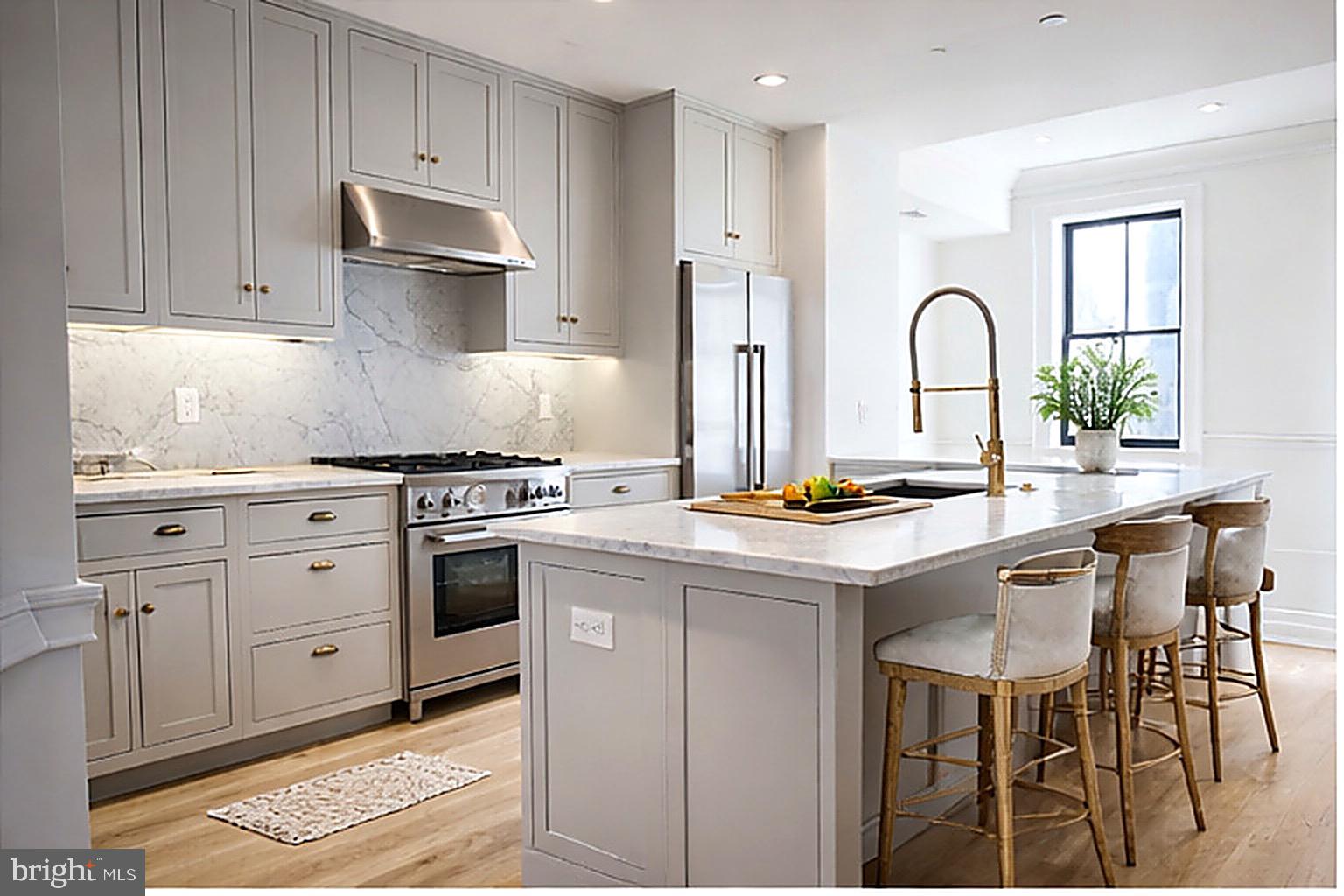 1227 North 6th Street Philadelphia, PA 19122 - Photo 2 of 32 a kitchen with white cabinets and appliances