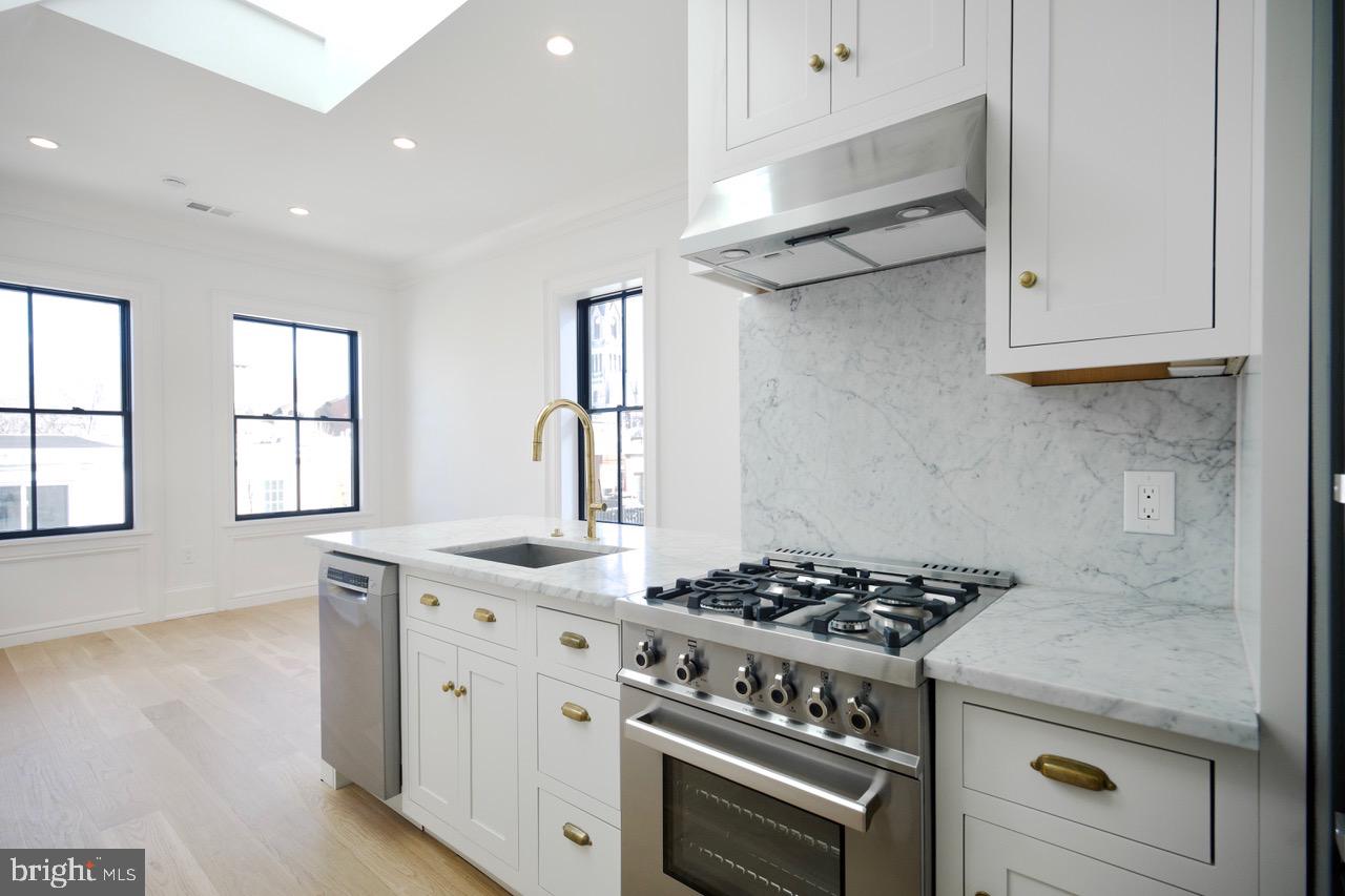1227 North 6th Street Philadelphia, PA 19122 - Photo 5 of 32 a white stove top oven sitting inside of a kitchen