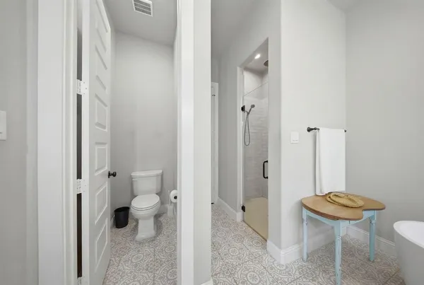 a bathroom with a toilet a sink and a large mirror