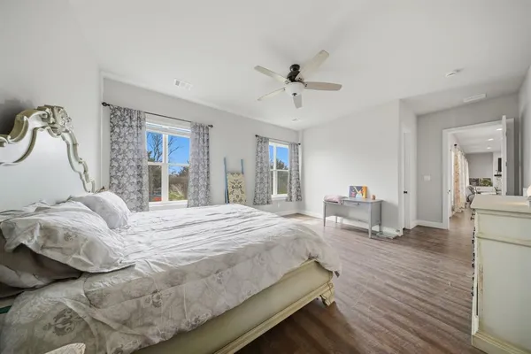 a bedroom with a bed couch and a window