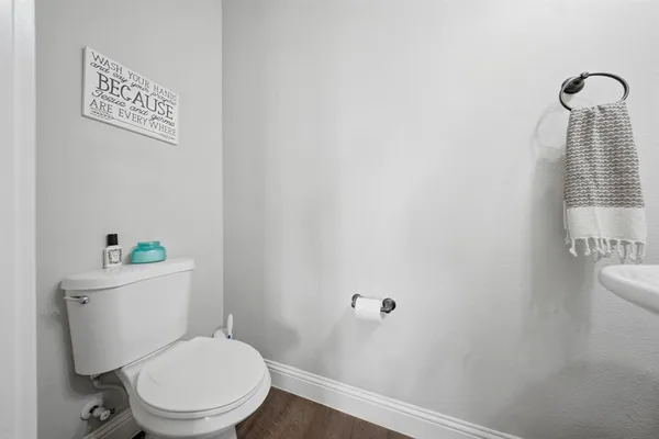 a white toilet sitting next to a shower