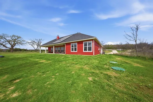 a front view of house with yard and green space