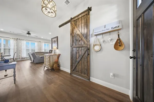 a view of a dining room with furniture and wooden floor