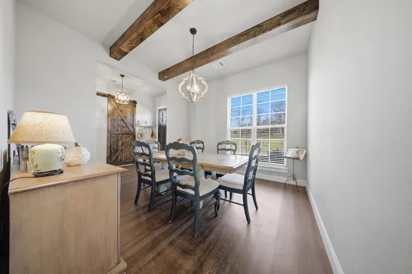 a dining room with furniture and wooden floor