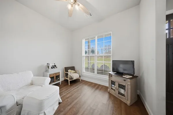a kitchen with stainless steel appliances white cabinets and wooden floors