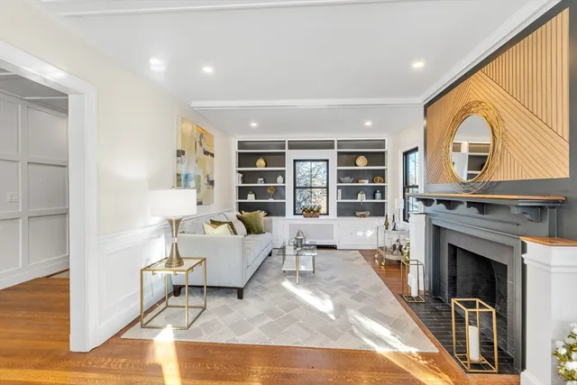 a living room with furniture a fireplace and a large window