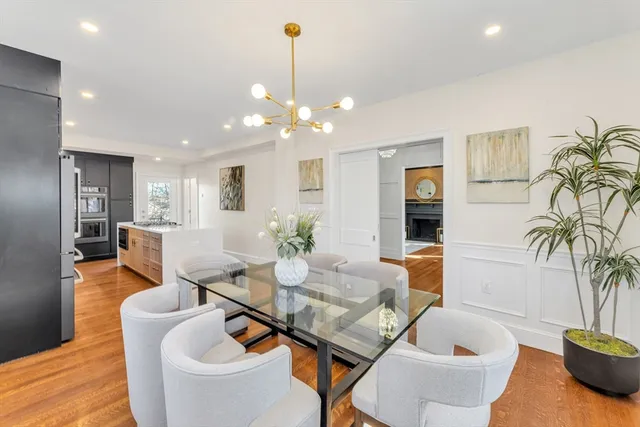 a living room with furniture a potted plant and a chandelier