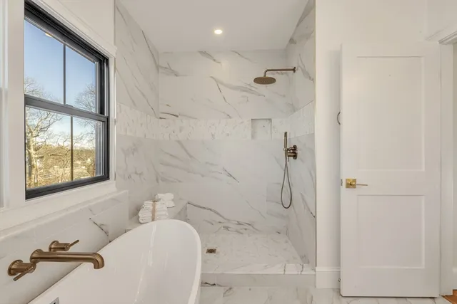 a bathroom with a bathtub and a shower