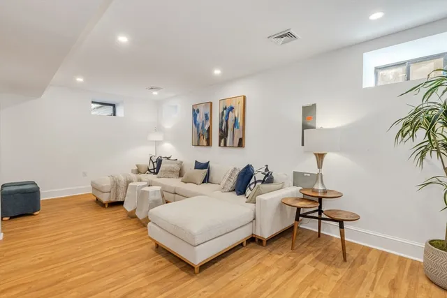 a living room with furniture and a wooden floor