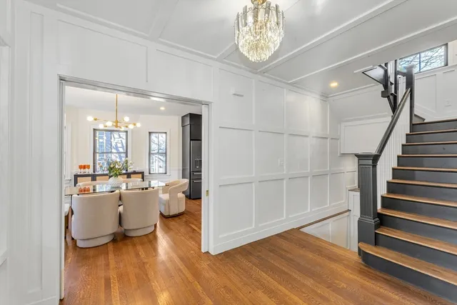 a view of a dining room with furniture wooden floor and chandelier