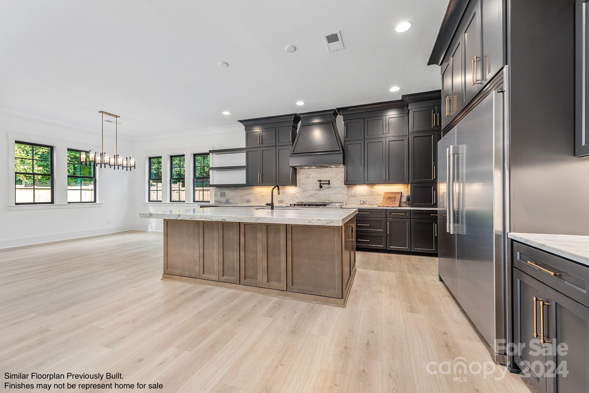 5521 Fairview Road Charlotte, NC 28209 - Photo 3 of 35 a large kitchen with kitchen island a large counter top and stainless steel appliances