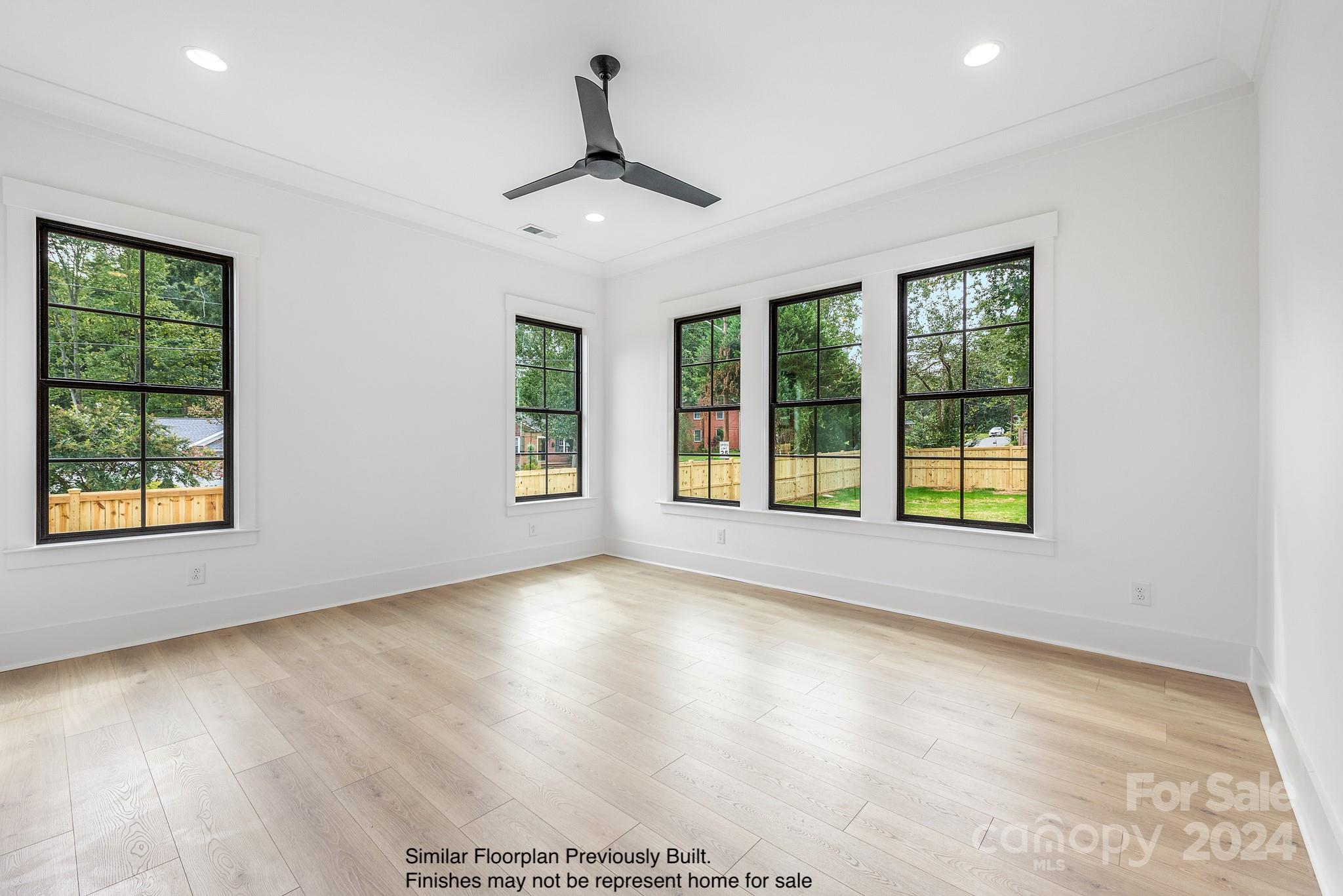 5521 Fairview Road Charlotte, NC 28209 - Photo 8 of 35 a view of an empty room with a window and wooden floor