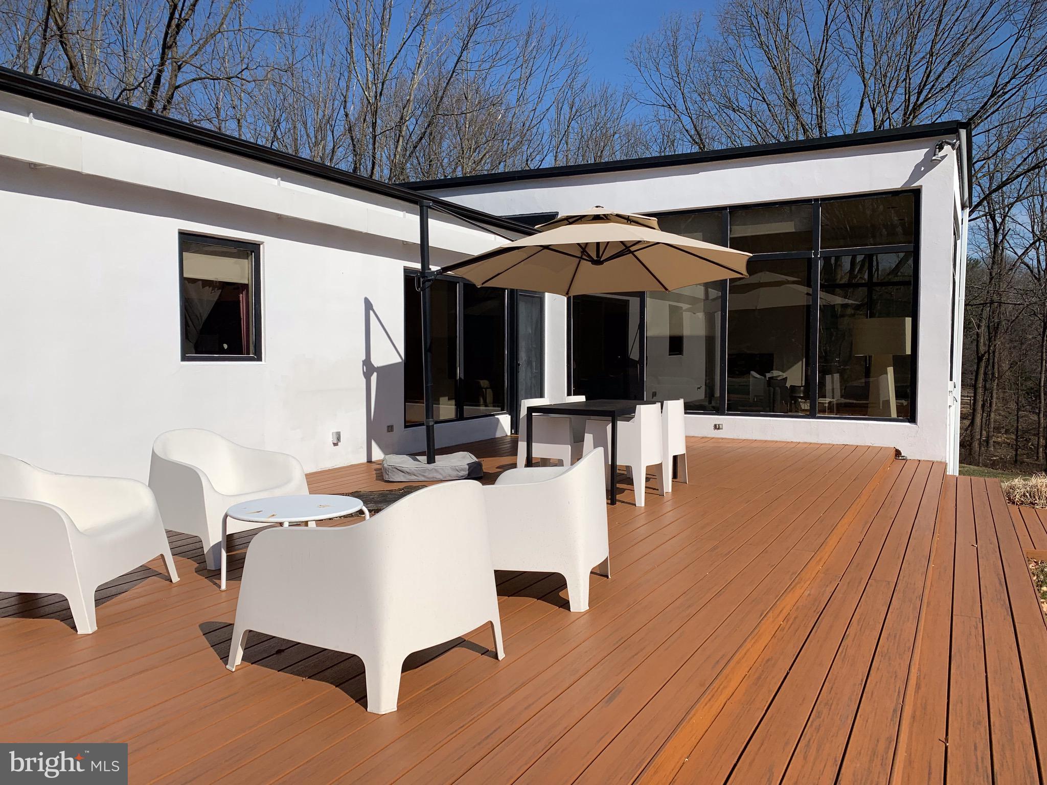 1371 Old Ford Road Huntingdon Valley, PA 19006 - Photo 7 of 37 a view of a patio with table and chairs under an umbrella with a small yard