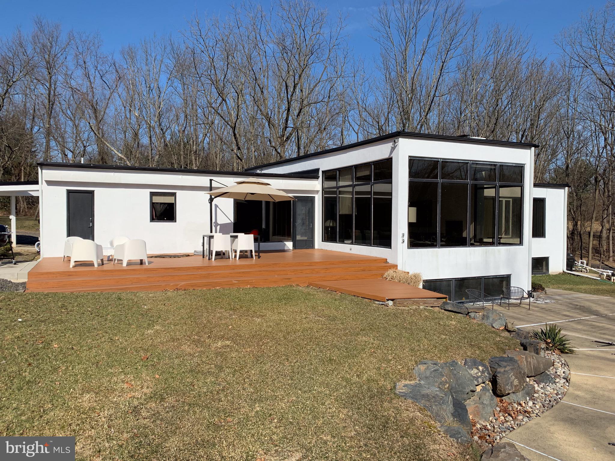 1371 Old Ford Road Huntingdon Valley, PA 19006 - Photo 8 of 37 a view of swimming pool with table and chairs under an umbrella with large trees