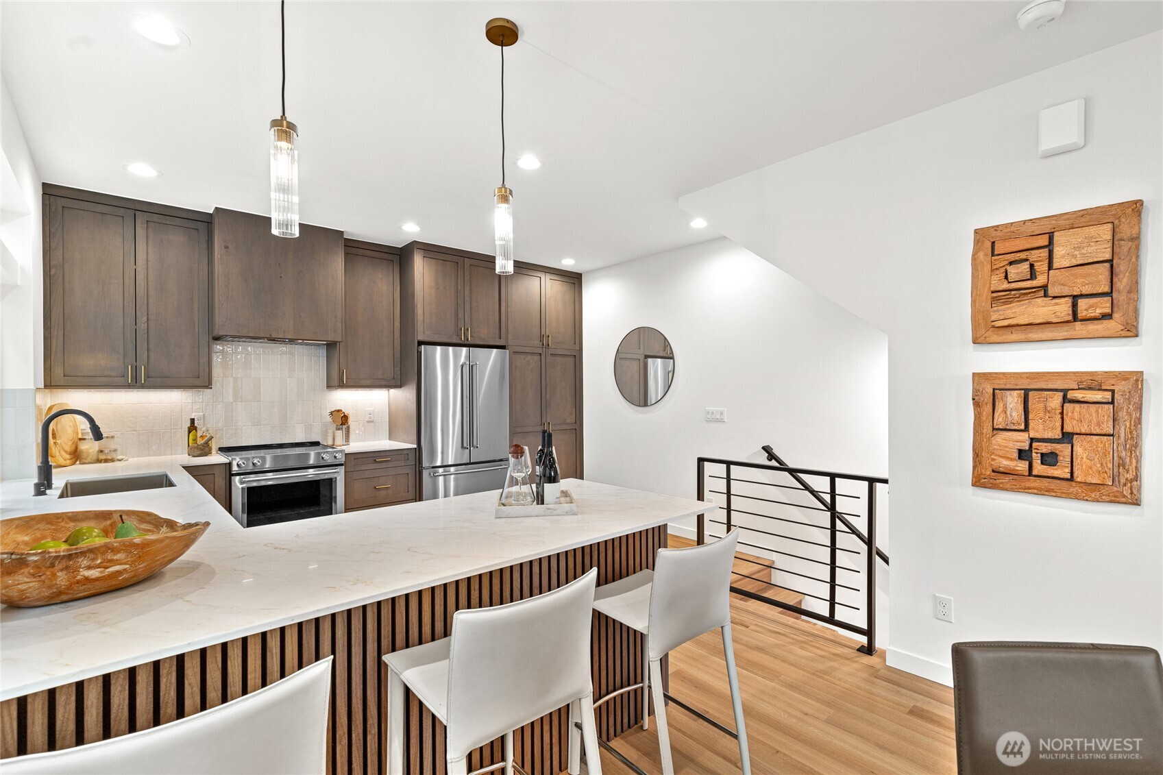 311 17th Avenue East Seattle, WA 98112 - Photo 11 of 39 a kitchen with kitchen island a dining table and chairs